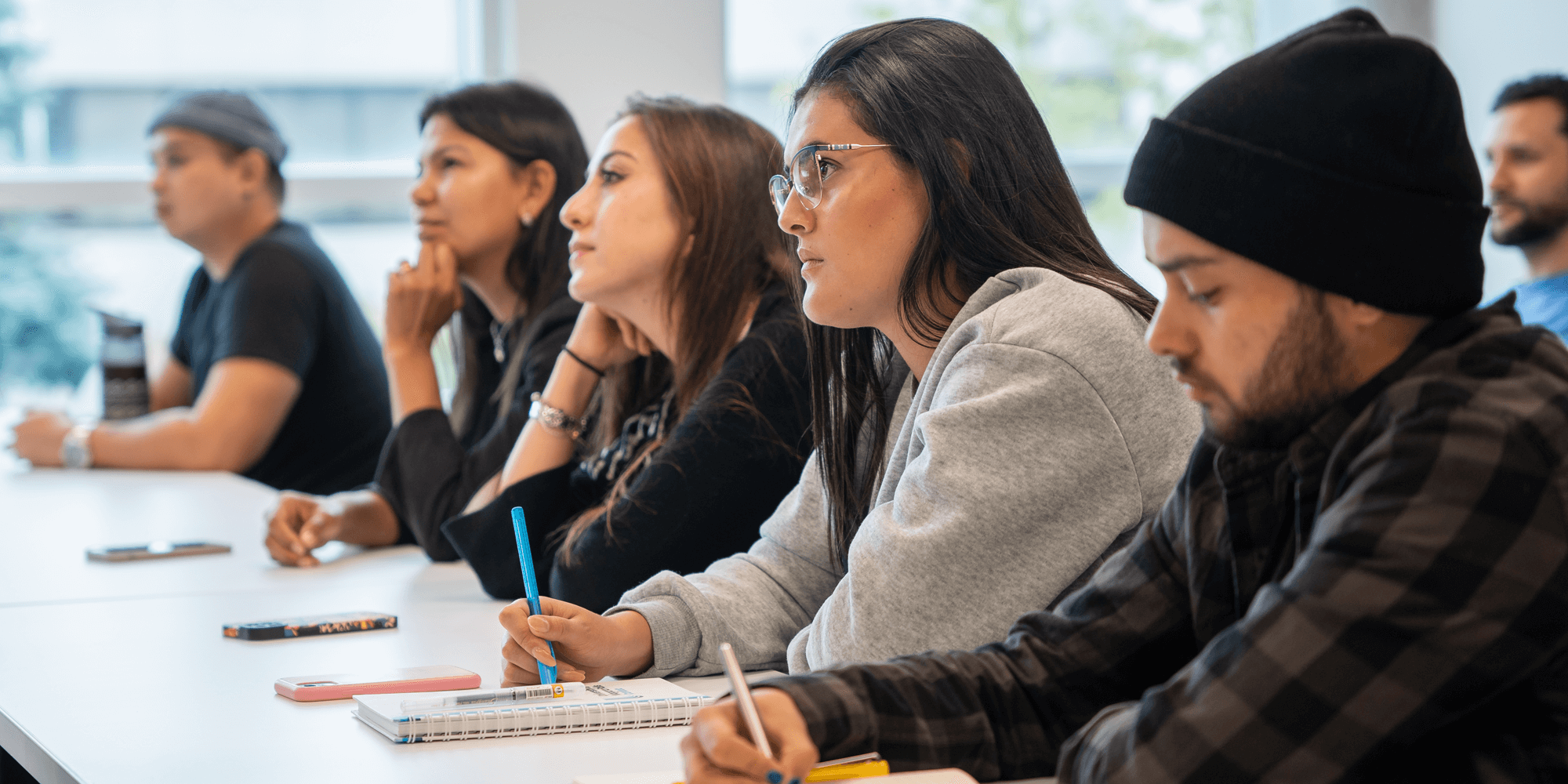 A group of students listening to the discussion on a classroom setting