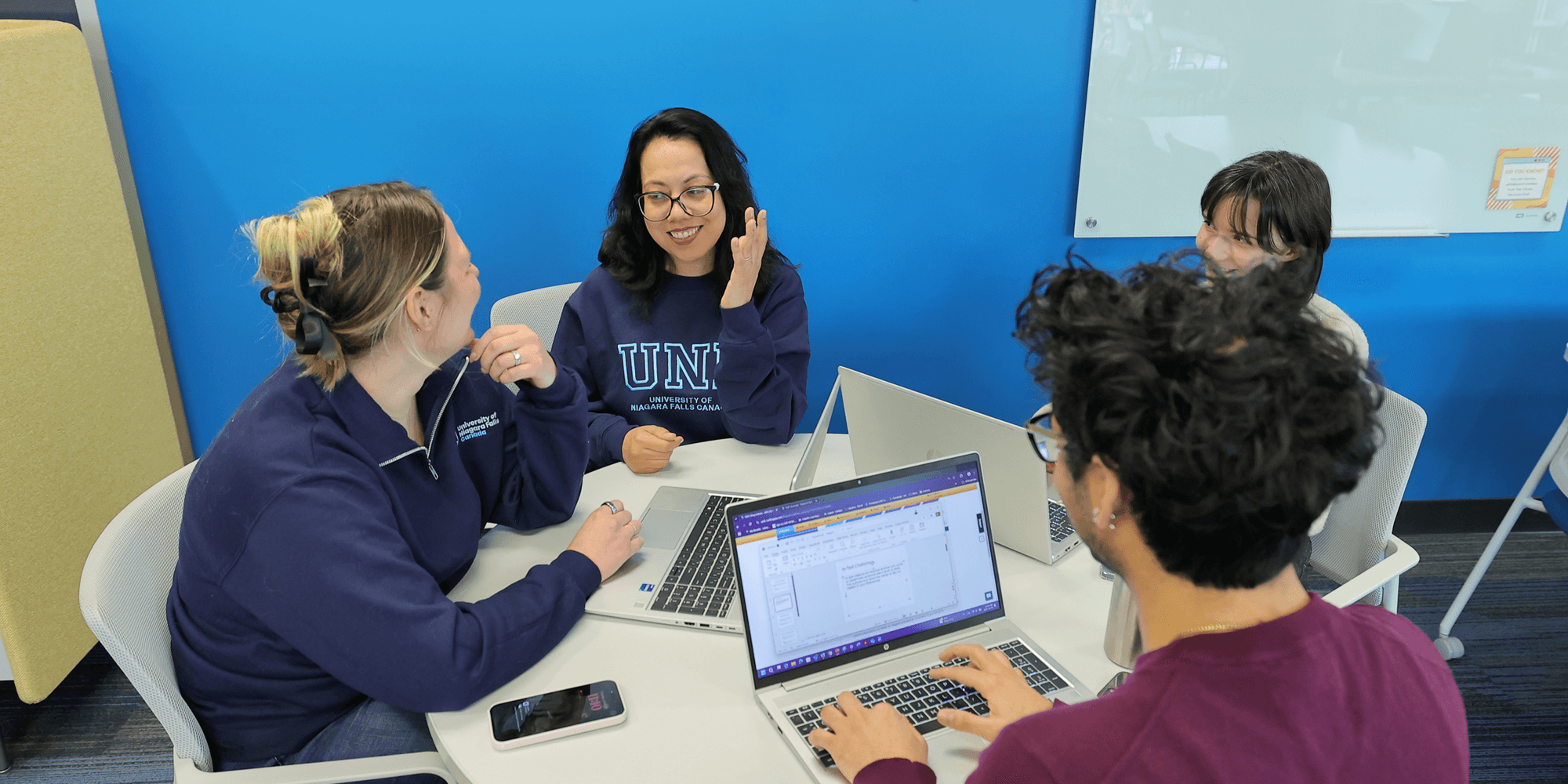 A group of students studying with their laptops