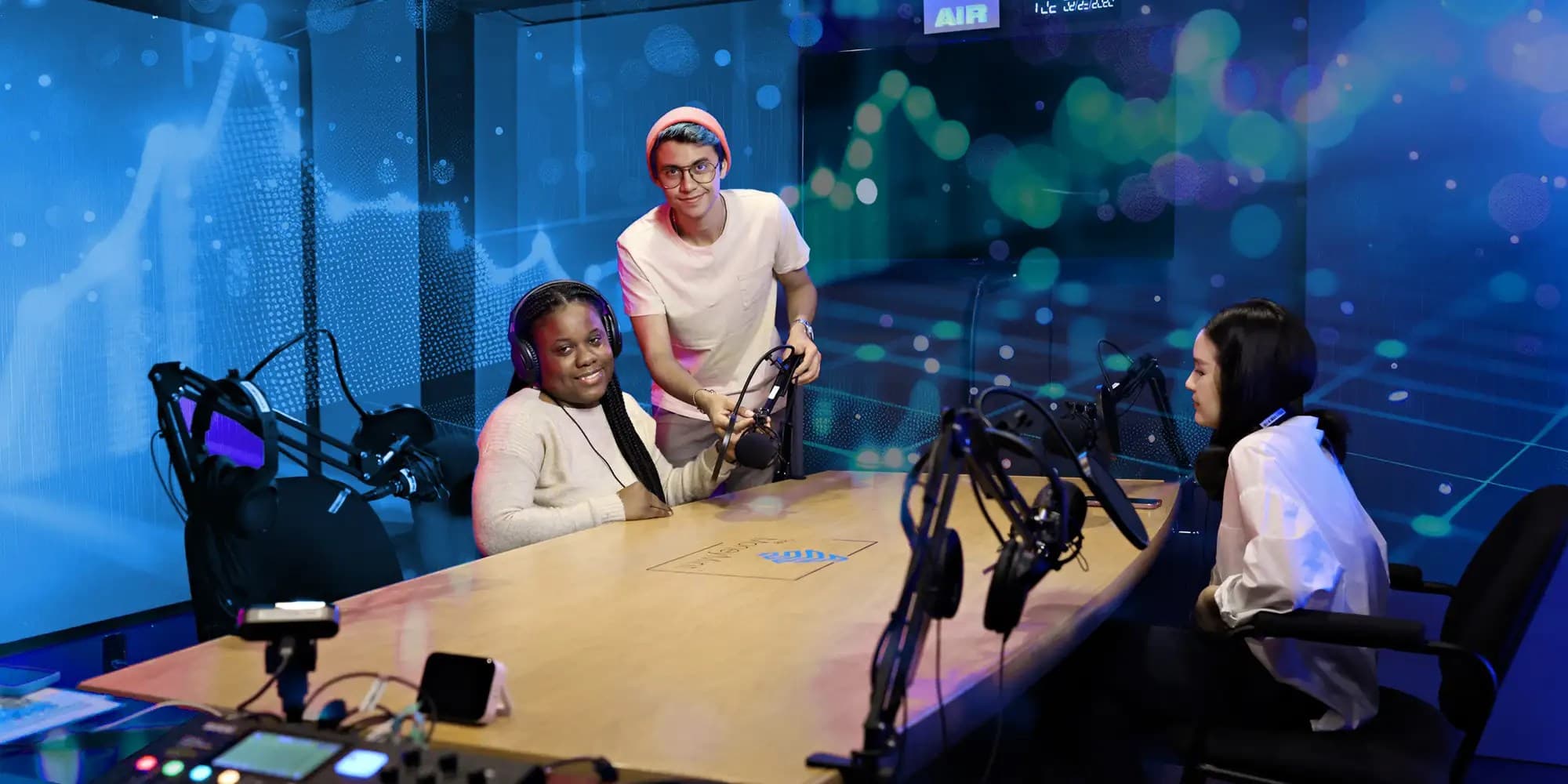 Group of UNF arts students siting inside the studio and working on podcast