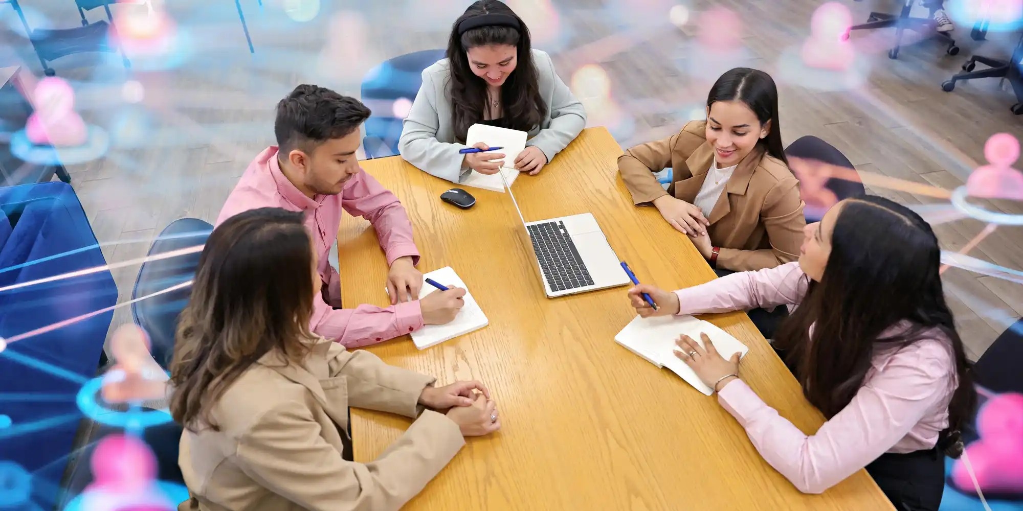 Group of UNF students sitting around a study table and taking notes while discussing