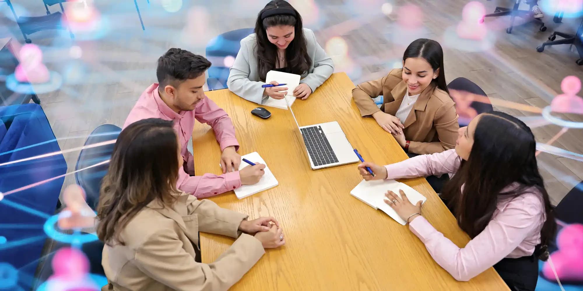 Group of UNF students sitting around a study table and taking notes while discussing