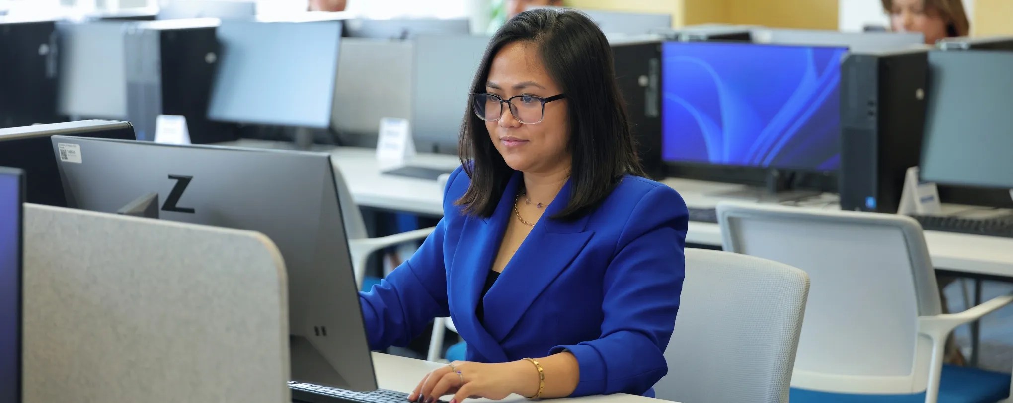 A UNF student working on a pc at the computer lab