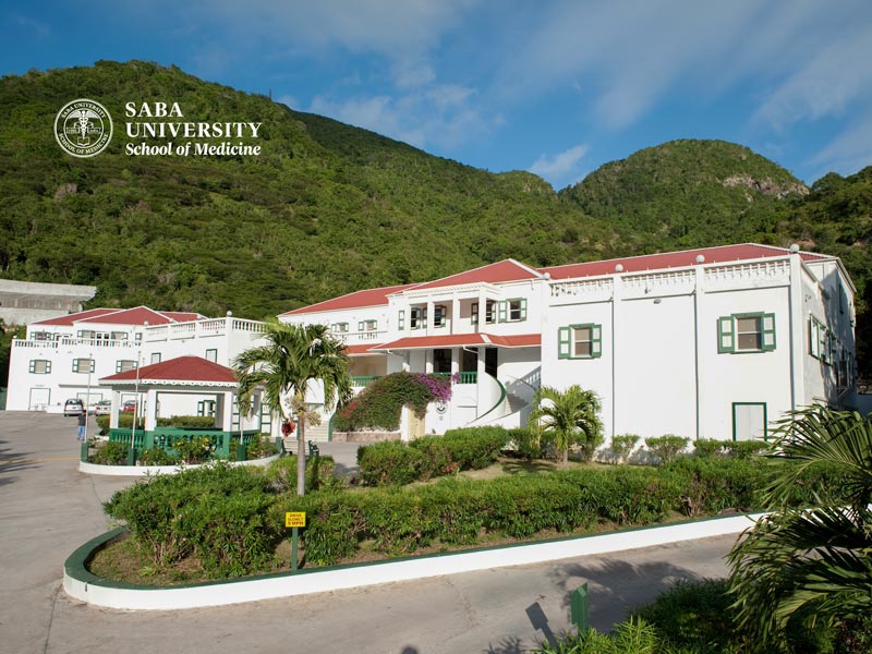 A picturesque view of Saba University located in St Kitts, surrounded by lush greenery and a serene atmosphere.