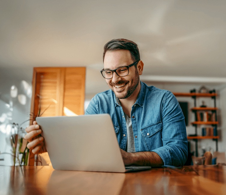 A guy smiling during online learning.