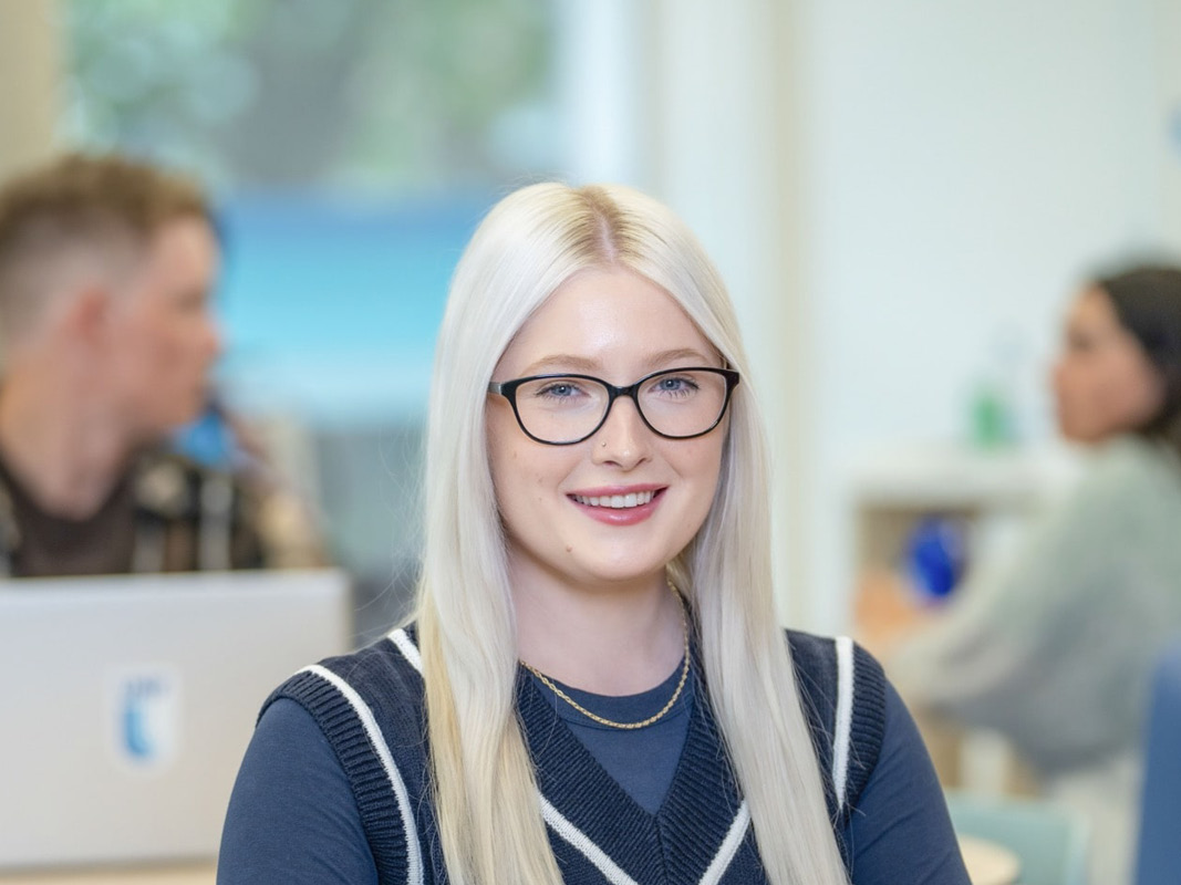 Young female sitting at a desk in an office setting